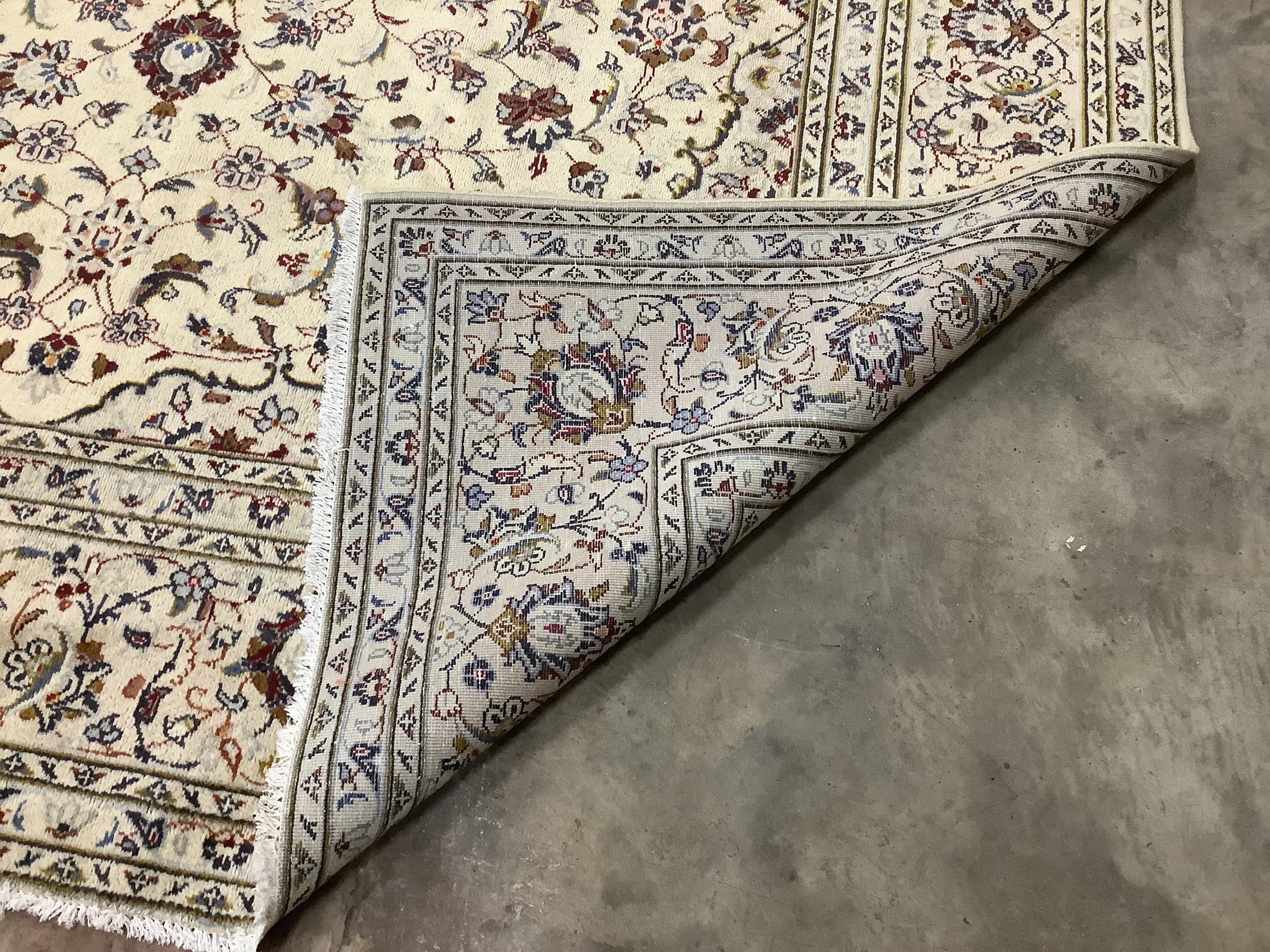 A Kashan ivory ground carpet, 345 x 245cm